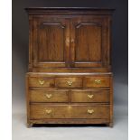 A Welsh oak linen press, 18th century, the moulded cornice above pair of paneled cupboard doors, the