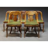 A set of five mahogany dining chairs, 19th Century, with curved backs centred by vase shaped