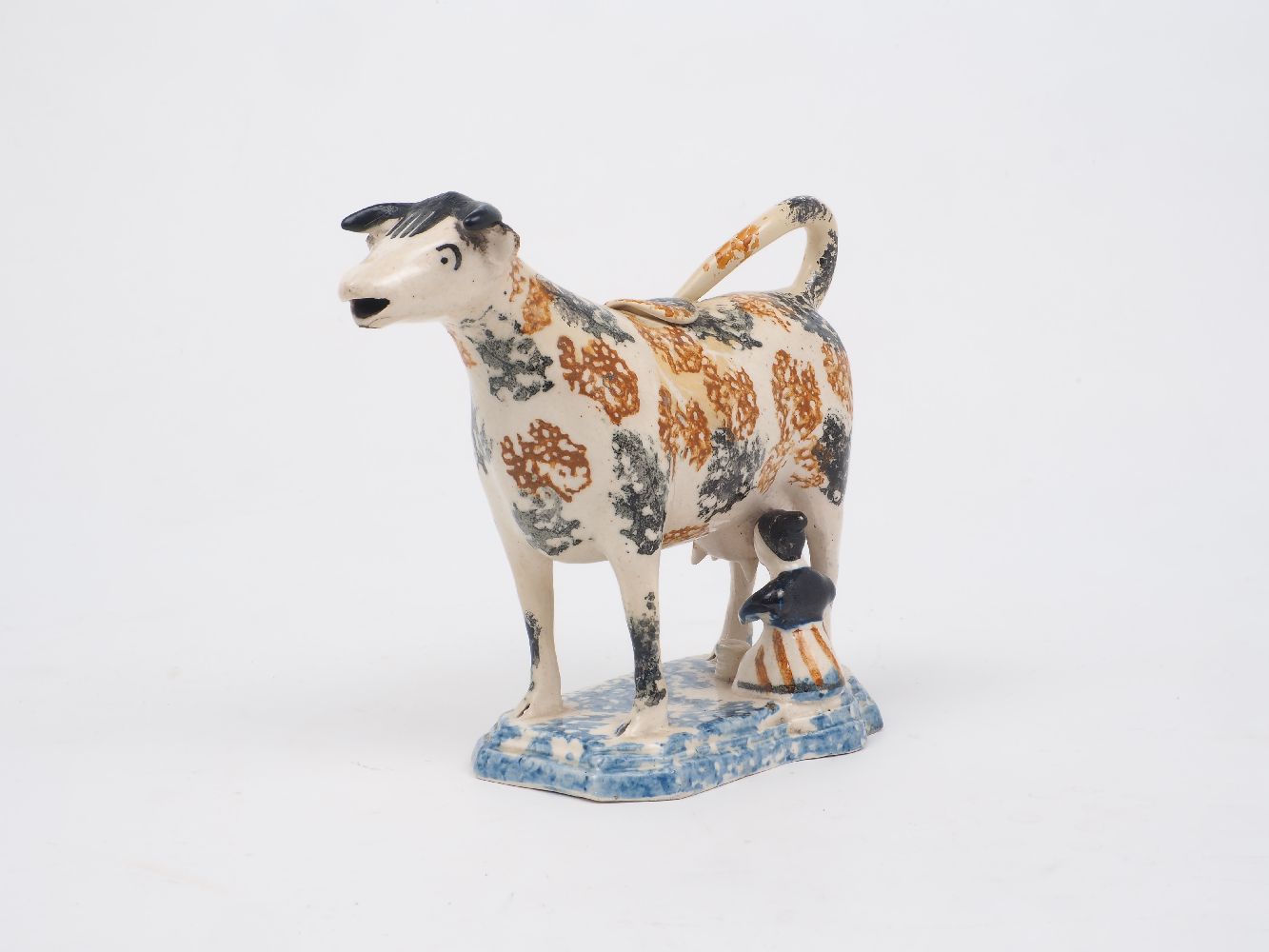 A Staffordshire pearlware cow creamer, late 18th/early 19th century, designed with a milkmaid and