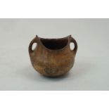 An antiquarian style terracotta vessel, of squat baluster form, with twin loop handles, pointed