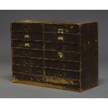 A desk top cabinet, early 20th Century, covered in faux leather effect paper, with two banks of