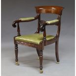 A Regency rosewood bar back armchair, with carved central rail, the scrolling arms above green