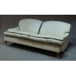 A three seat sofa, possibly George Smith, raised on brass casters and turned wood legs, George Smith