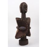 A carved wood African sculpture, 20th century, featuring a double Yoruba style head with carved
