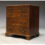 A George III oak chest, with four long graduated drawers, raised on shaped bracket feet, 74cm