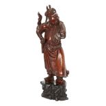 A Chinese hardwood carving of an immortal, 19th century, carved with a long beard and flowing robes,