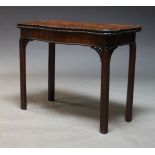 A George III style mahogany serpentine card table, late 19th, early 20th Century, the fold over top,