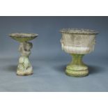 A composite stone bird bath, late 20th Century, modeled as an urn with lions head handles, 64cm