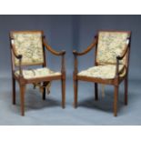 A pair of Edwardian mahogany open armchairs, with square backs and curved armrests, upholstered in