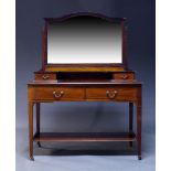 An Edwardian mahogany dressing table, the top surmount with mirror and set back drawers, the