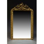 A large gilt framed Rococo taste overmantle mirror, 19th Century, of arched form, the pierced