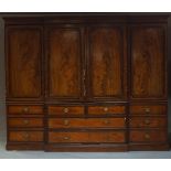 A Regency mahogany triple breakfront wardrobe, early 19th century, the moulded cornice above two