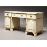 A white painted and parcel gilt dressing table, late 20th Century, the shaped top above three frieze