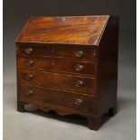 A George III mahogany and line inlaid bureau, the fall enclosing later green baize lined writing