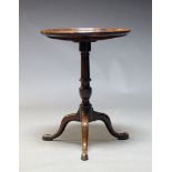 A George III mahogany tilt-top occasional table, the circular tray top on turned column support to