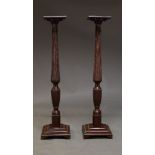 A pair of mahogany torchere stands, late 20th Century, with square shelf on tapering fluted