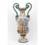 An Italian majolica twin handled urn form vase, late 19th century, with green snake form handles