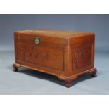 A Chinese camphorwood chest, late 20th Century, with carved bamboo motifs, raised on ogee style