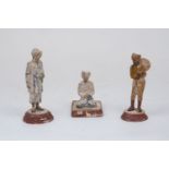 Three terracotta models of servants, probably Bengali, 19th Century, modelled as a waiter, darning