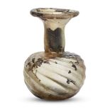 AMENDMENT. Please note this lot is 20th Century. A Roman yellowish glass sprinkler flask, Eastern