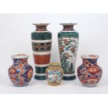A pair of Japanese porcelain vases, Meiji period, of inverted baluster form with high shoulder,