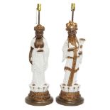 A pair of large Chinese style terracotta figural lamps, 20th century, modelled as standing immortals