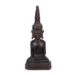 A Chinese carved hardwood Buddha, late 19th/early 20th century, modelled seated, to a canted