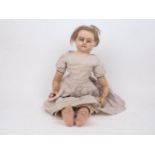 A Victorian wax over composition doll, circa. 1850, in original clothes, inserted hair, set with