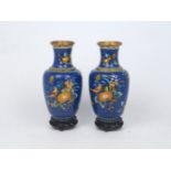 A pair of Chinese cloisonne vases, 20th century, decorated with birds and foliage on a blue