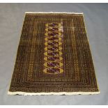 A Tekke rug, with a row of octagonal guls in a olive green field, 171cm x 120cmnumerous areas of