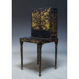 A black Japanned and parcel gilt bonheur du jour, mid 19th Century, overall decorated with flora and