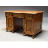 A Victorian walnut kneehole desk, the later top inset with brown leatherette writing surface,