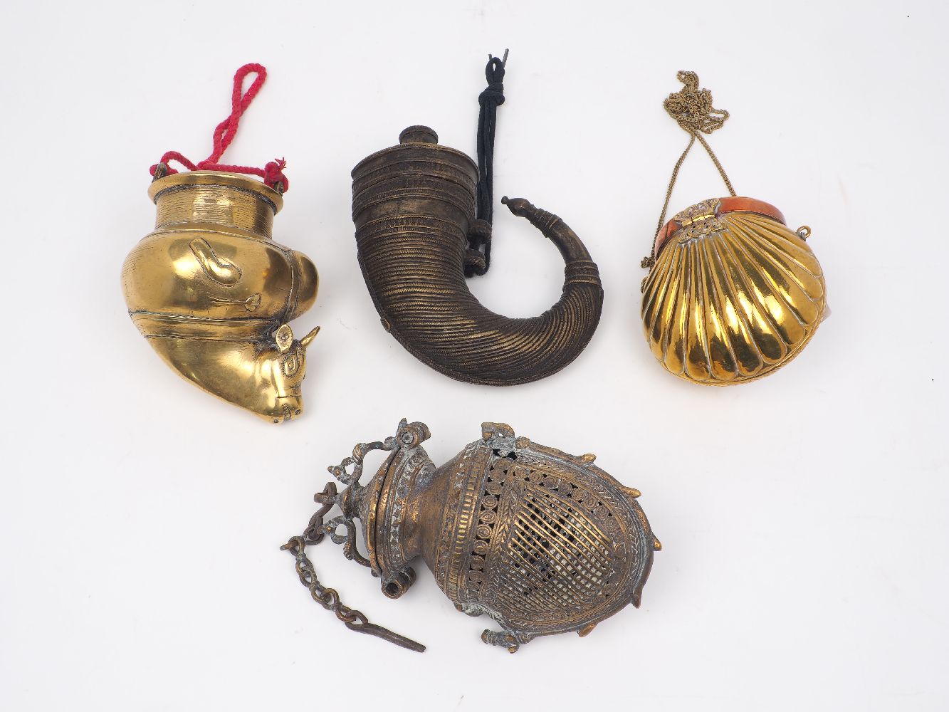 A group of four of Indian brass vessels, 20th century, to include: a shell form purse, with hinged