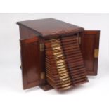 A late Victorian mahogany table top specimen cabinet, with two panelled doors, enclosing twenty