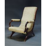 A Regency mahogany armchair, with curved backrest and scrolling arms, upholstered in blue and