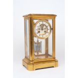 A French brass framed four-glass mantle clock, 19th century, of architectural plinth form, the