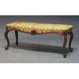 A Victorian rosewood duet stool, with floral upholstered seat, on cabriole legs, 47cm high, 112cm