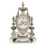 A French silvered bronze mantle clock, c.1870, the case with swagged urn finial, the dial with Roman