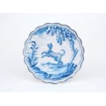 A Dutch Delft cabinet plate, late 19th/early 20th century, possibly 'Die Drie Klokken', of scalloped