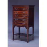 An Edwardian mahogany and satinwood banded music cabinet, with five fall-front drawers, on square