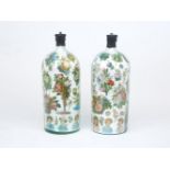A pair of Victorian decalcomania bottle vases, each painted with floral sprays, roses, baskets of