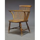 An elm, yew and beech comb back Windsor armchair, late 19th, early 20th Century, with comb back