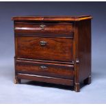 A German mahogany commode, 19th Century, the shaped and crossbanded top, with three drawers on block