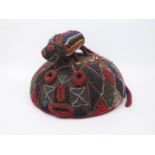 A West African beaded headdress, of inverted bowl form, surmounted by a rat, all decorated in