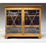 An Edwardian mahogany and line inlaid bookcase, with moulded cornice above astragal glazed doors