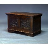 A 17th Century style oak coffer, 20th Century, with overall carved floral decoration, on shaped