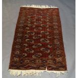 A Tekke rug, with octagonal guls in a deep red field, 178cm x 106cmPlease refer to department for