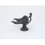 A bronze oil lamp with three spouts and horse handle, with large naskh Arabic inscription to body,