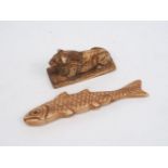 A carved bone fragment, designed as a fish, with scale details, 10cm long, together with a bone