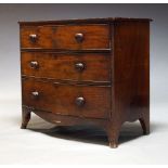 A Victorian mahogany bow-front chest, with three long graduated drawers, raised on splayed bracket